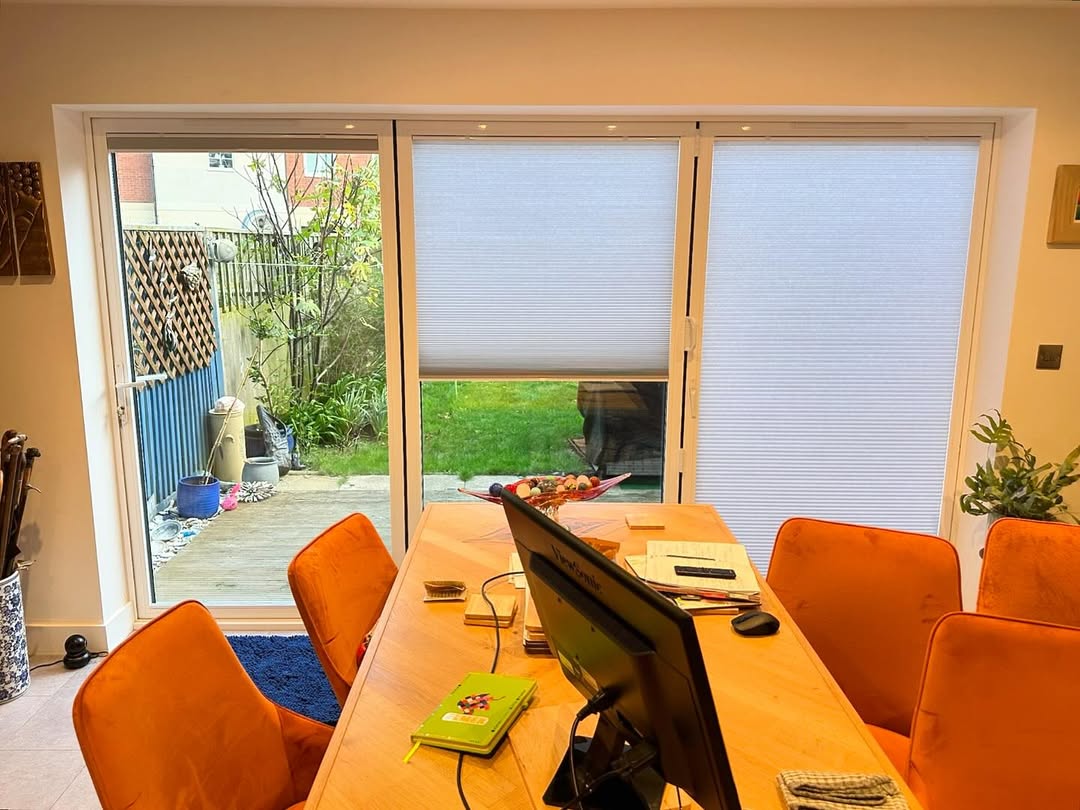 Pleated blinds on bi-fold doors half open