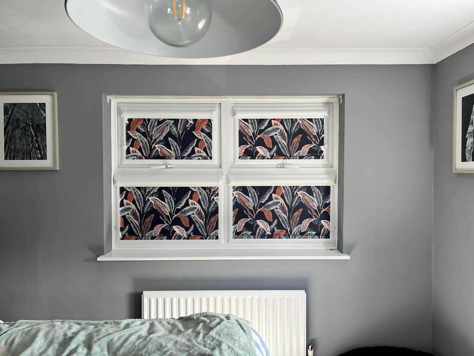 Patterned roller blinds in a bedroom