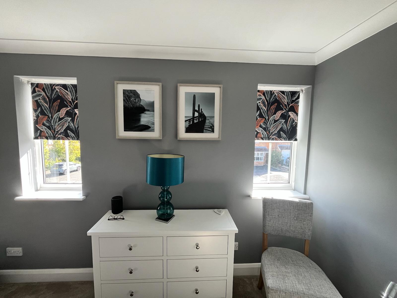 Matching patterned roller blinds in a bedroom