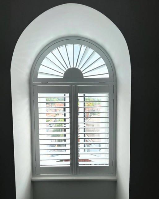 Arched window shutters with sunburst top
