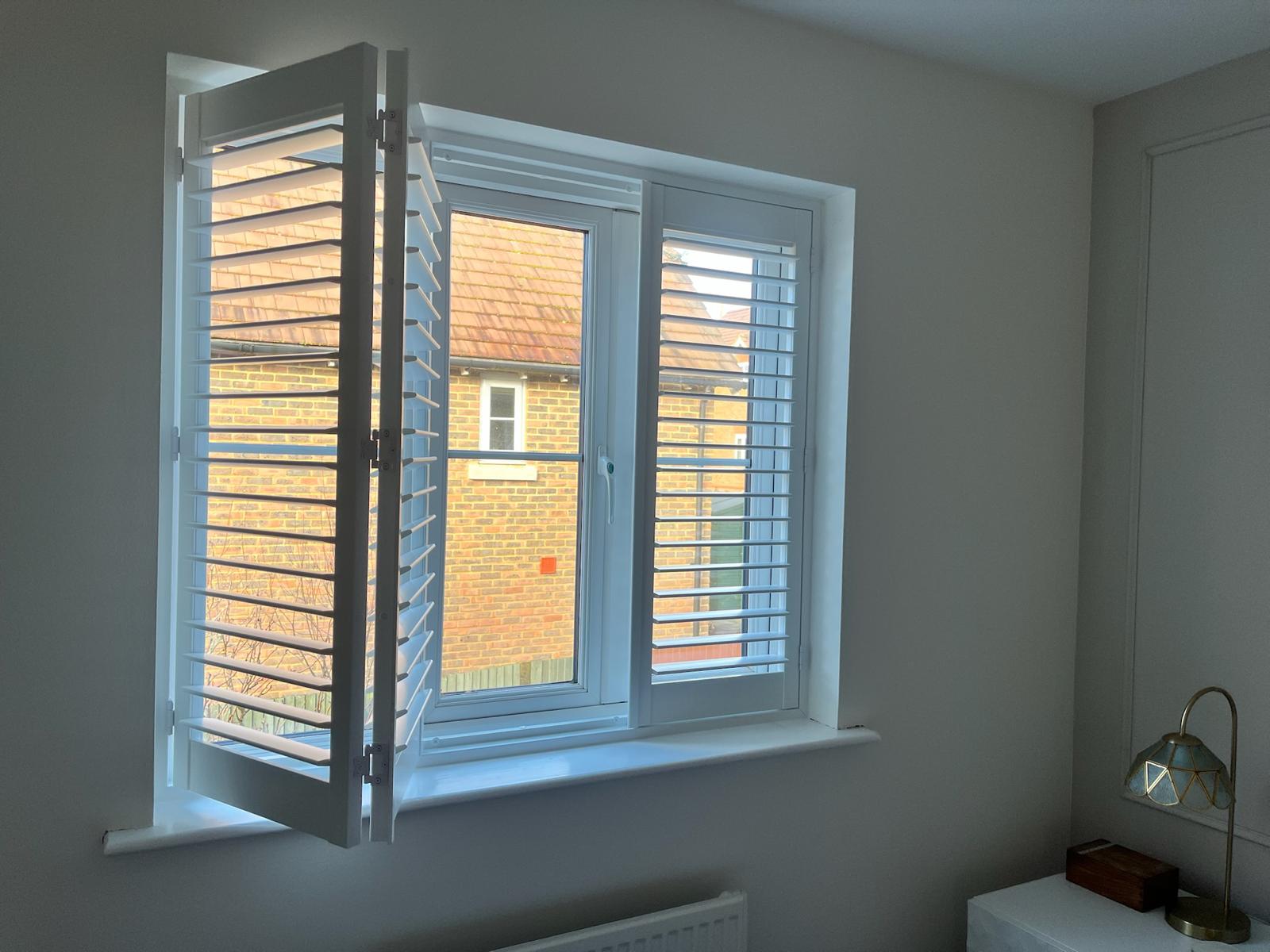 Bedroom shutters with bedside lamp