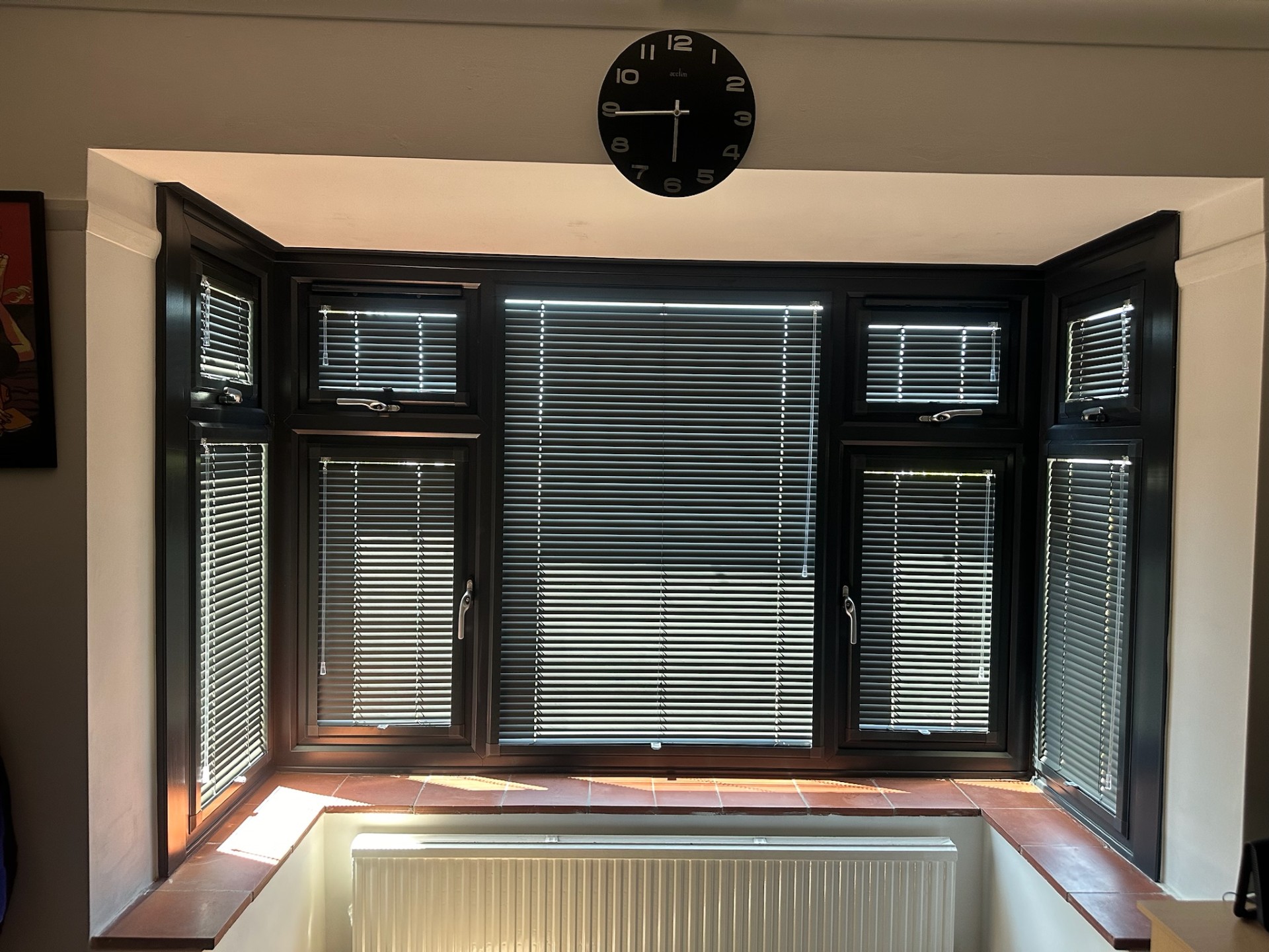 Dark venetian blinds on a bay window