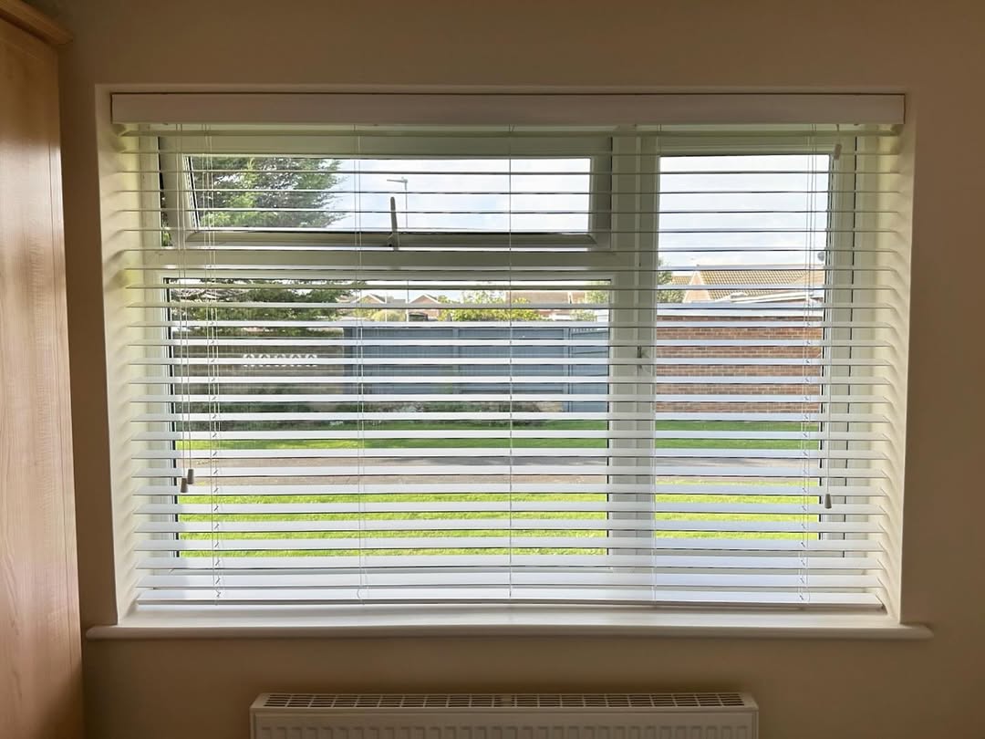 White venetian blinds in a bedroom